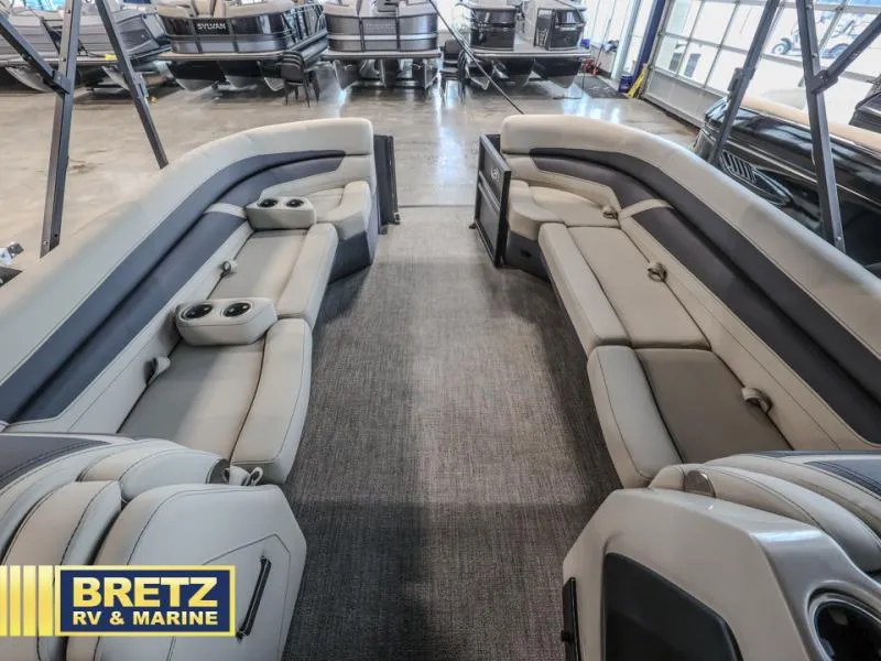 Slide: The Image of 2023 Cabrio 24UC boat interior with plush seating and cup holders at Bretz RV & Marine. - 14