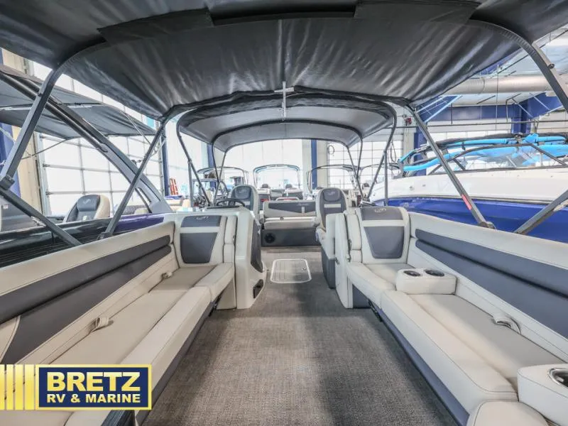 Slide: The Image of 2023 Cabrio 24UC boat interior with spacious seating, showcased at Bretz RV & Marine. - 15
