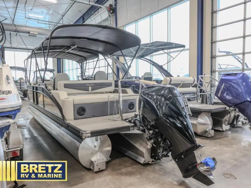 Slide: The Image of 2023 Cabrio 24UC pontoon boat in showroom, featuring sleek design and powerful outboard motor. - 4