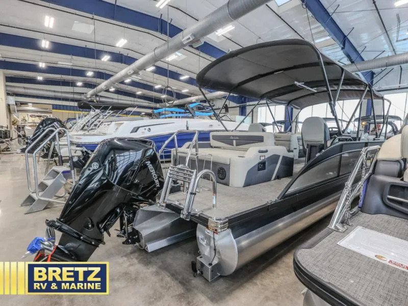 Slide: The Image of 2023 Cabrio 24UC pontoon boat displayed at Bretz RV & Marine showroom. - 5