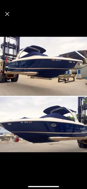 The Image of 2013 Regal 2700 ES Bowrider boat in a marina, elevated by a forklift. - 0