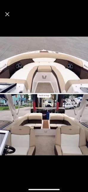 Slide: The Image of 2013 Regal 2700 ES Bowrider boat interior with beige seating and spacious layout. - 2