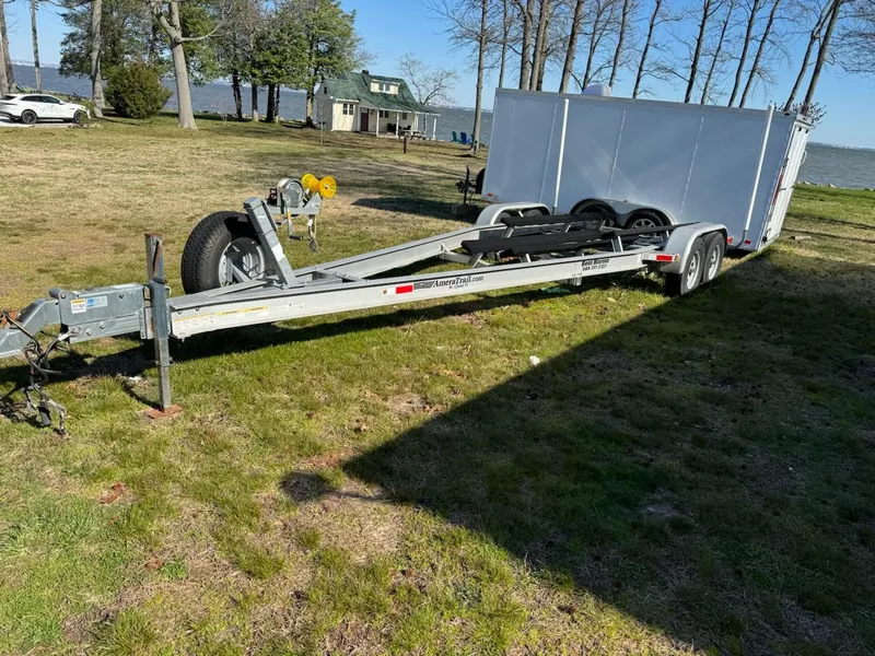 Slide: The Image of Trailer for 2013 Regal 2700 ES Bowrider on grassy lakeside area. - 7