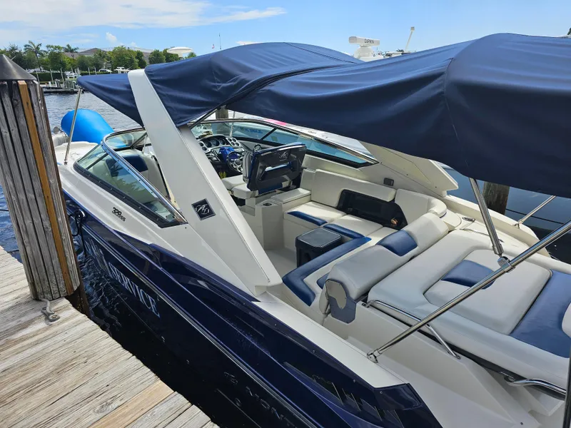 Slide: The Image of 2012 Monterey 328SS Super Sport boat docked with blue canopy and spacious seating. - 10