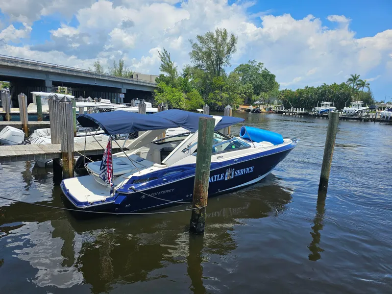 Slide: The Image of 2012 Monterey 328SS Super Sport boat docked on a sunny day with blue skies. - 11