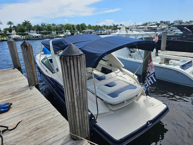 Slide: The Image of 2012 Monterey 328SS Super Sport boat docked at marina with blue canopy. - 9
