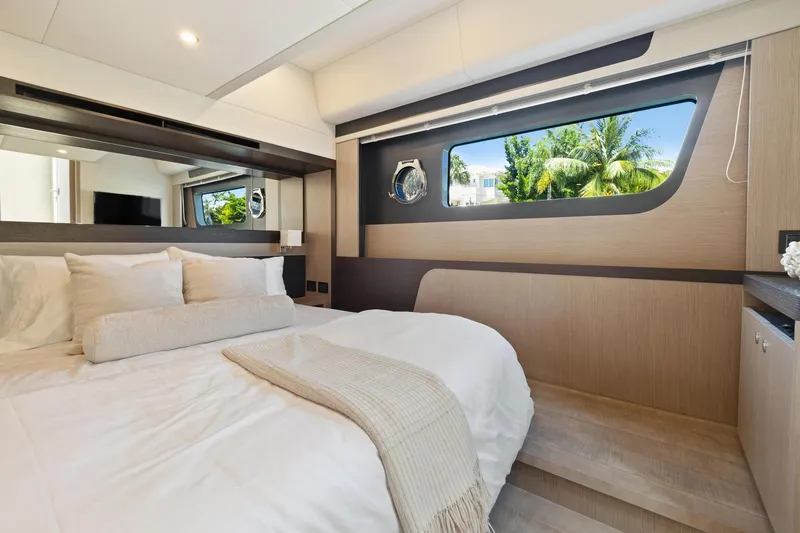 Slide: The Image of Luxurious bedroom interior of 2022 Absolute 48 Coupe yacht with modern design and large window. - 28
