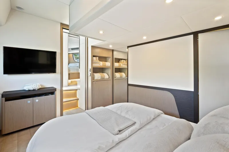 Slide: The Image of Luxurious interior of 2022 Absolute 48 Coupe yacht with modern bedroom and TV. - 29