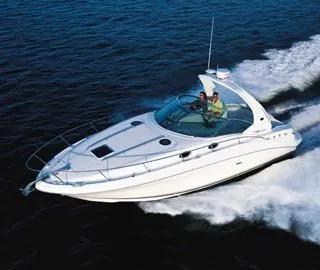 The Image of 2003 Sea Ray 320 Sundancer cruising on open water, showcasing sleek design and performance. - 0