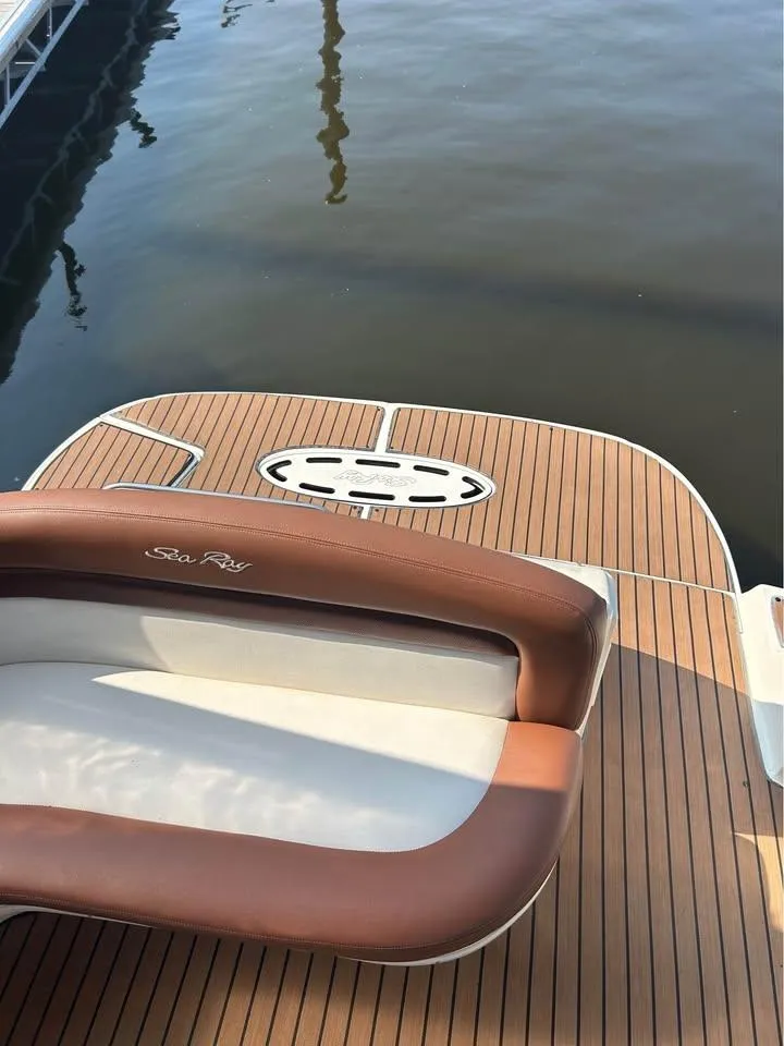 Slide: The Image of 2003 Sea Ray 320 Sundancer boat with teak deck and cushioned seating at the dock. - 14