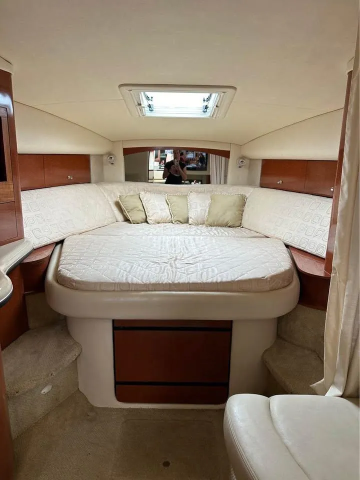 Slide: The Image of 2003 Sea Ray 320 Sundancer cabin with cozy bed and skylight. - 16