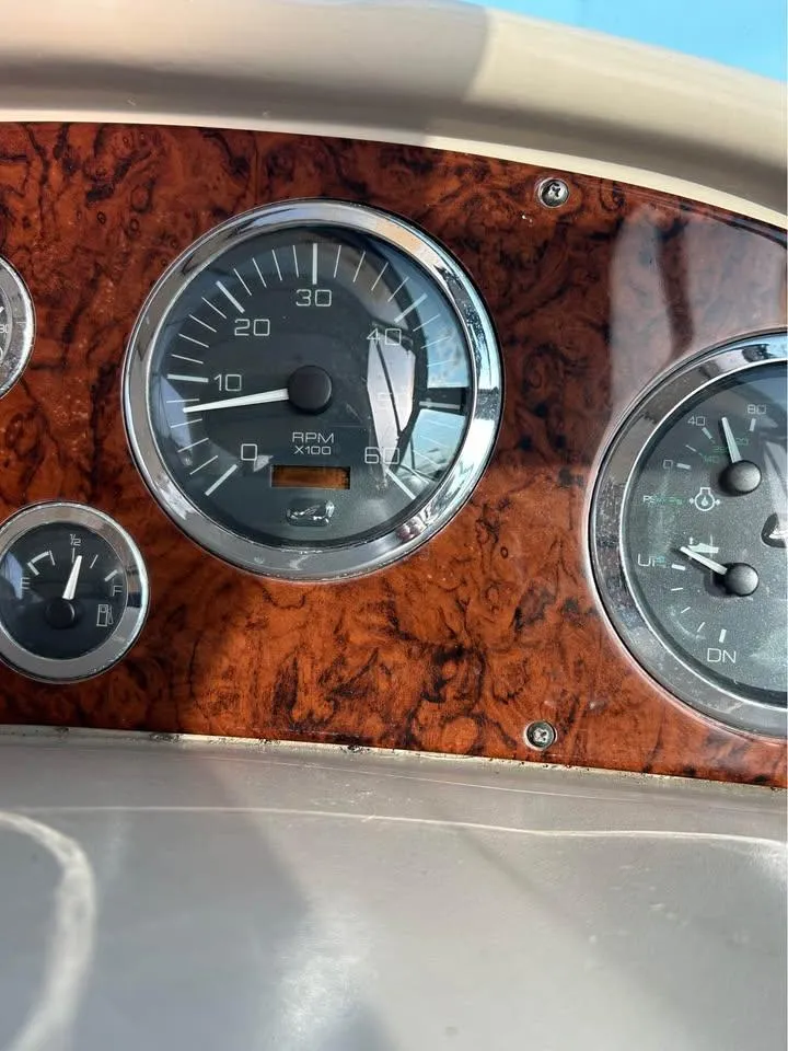 Slide: The Image of Dashboard of 2003 Sea Ray 320 Sundancer with wood paneling and gauges. - 6