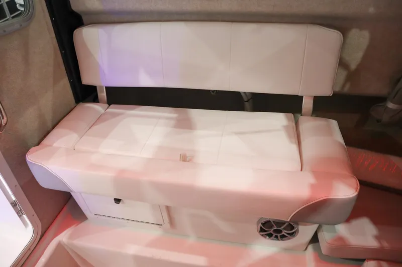 Slide: The Image of 2025 Parker 2120 Sport Cabin interior seating with white upholstery and built-in speaker. - 11