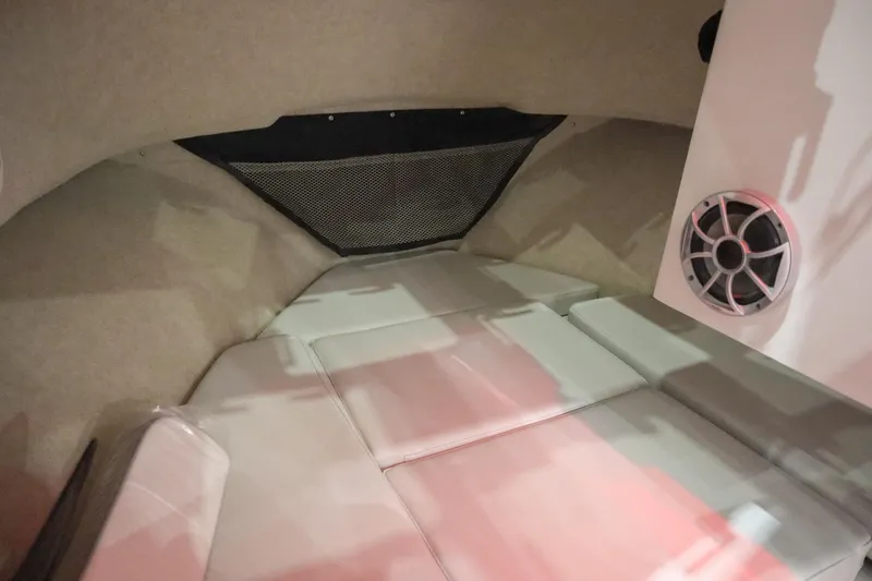 Slide: The Image of Interior cabin of 2025 Parker 2120 Sport Cabin boat with cushioned seating and speaker. - 14