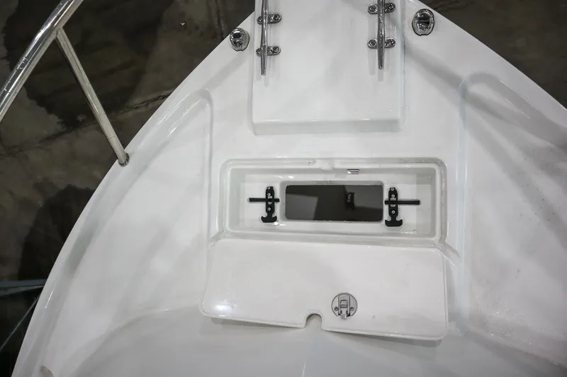 Slide: The Image of 2025 Parker 2120 Sport Cabin boat deck with storage compartment and stainless steel fittings. - 19