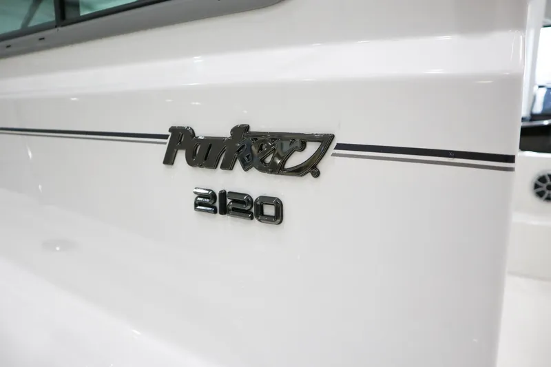 Slide: The Image of 2025 Parker 2120 Sport Cabin boat logo on white exterior. - 20