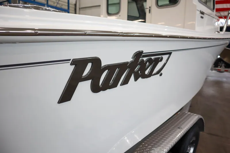 Slide: The Image of 2025 Parker 2120 Sport Cabin boat, close-up of logo on white hull. - 22