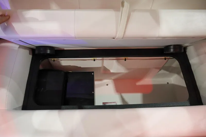 Slide: The Image of 2025 Parker 2120 Sport Cabin storage compartment with open lid, showcasing interior space. - 24