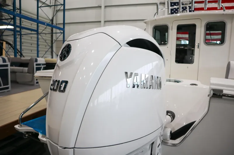 Slide: The Image of Parker 2120 Sport Cabin 2025 with Yamaha outboard engine in showroom. - 6