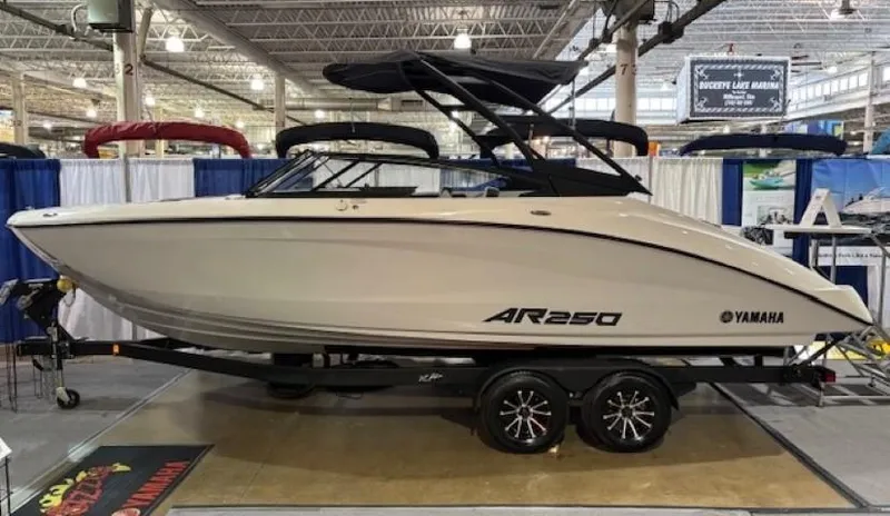The Image of 2025 Yamaha Boats AR250 displayed indoors on a trailer. - 0