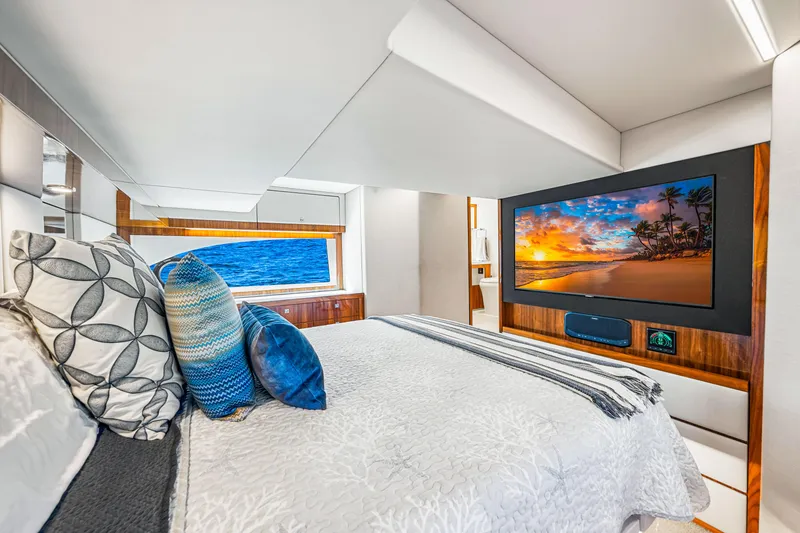 Slide: The Image of Luxurious bedroom interior of 2022 Riviera 505 SUV yacht with ocean view and TV. - 19