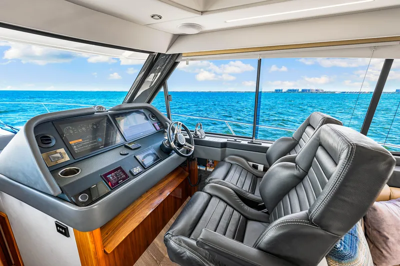 Slide: The Image of Interior of 2022 Riviera 505 SUV yacht with ocean view and modern dashboard. - 26