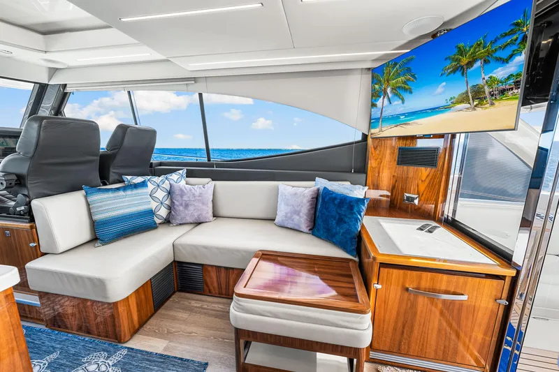 Slide: The Image of Luxurious interior of 2022 Riviera 505 SUV yacht with plush seating and ocean view. - 32