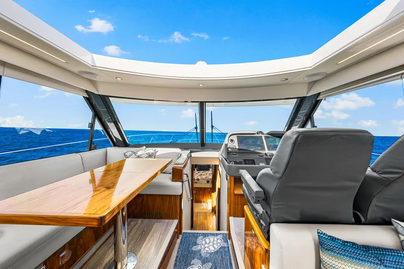 Slide: The Image of Interior of 2022 Riviera 505 SUV yacht with ocean view and luxurious seating. - 30