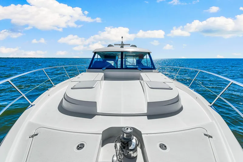 Slide: The Image of 2022 Riviera 505 SUV yacht cruising on open sea under blue sky. - 43