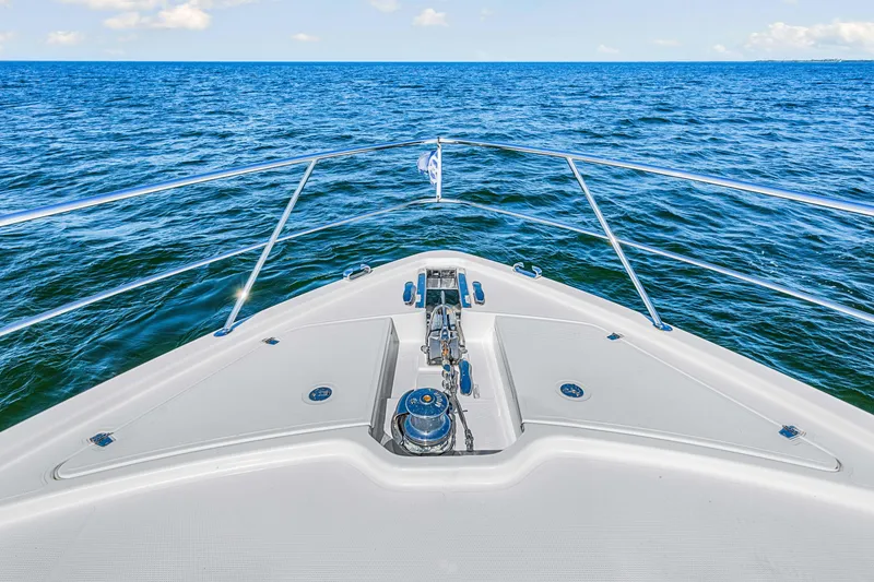 Slide: The Image of Bow view of 2022 Riviera 505 SUV yacht cruising on open sea. - 45