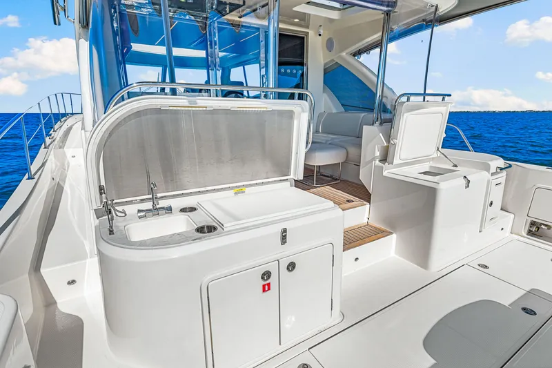 Slide: The Image of 2022 Riviera 505 SUV yacht interior with sleek kitchen and seating area, ocean view. - 46
