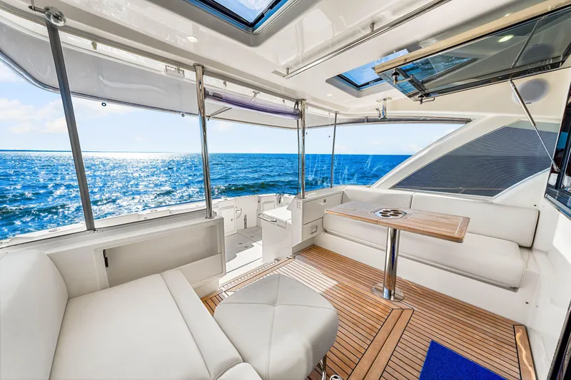 Slide: The Image of Luxurious 2022 Riviera 505 SUV yacht interior with ocean view and elegant seating area. - 37