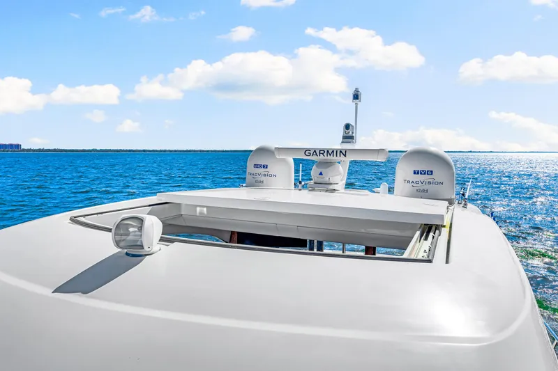 Slide: The Image of 2022 Riviera 505 SUV yacht with Garmin equipment, cruising on a sunny ocean. - 44