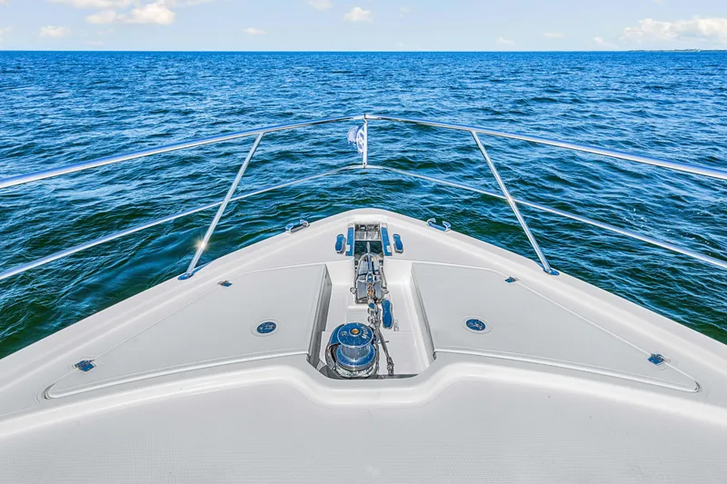 Slide: The Image of Bow view of 2022 Riviera 505 SUV yacht cruising on open sea. - 45
