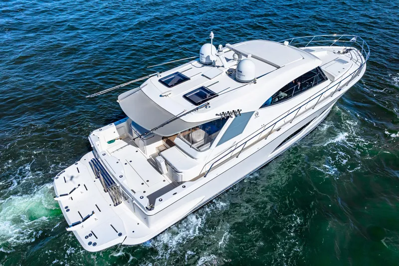 Slide: The Image of 2022 Riviera 505 SUV cruising on open water, showcasing sleek design and luxury features. - 7