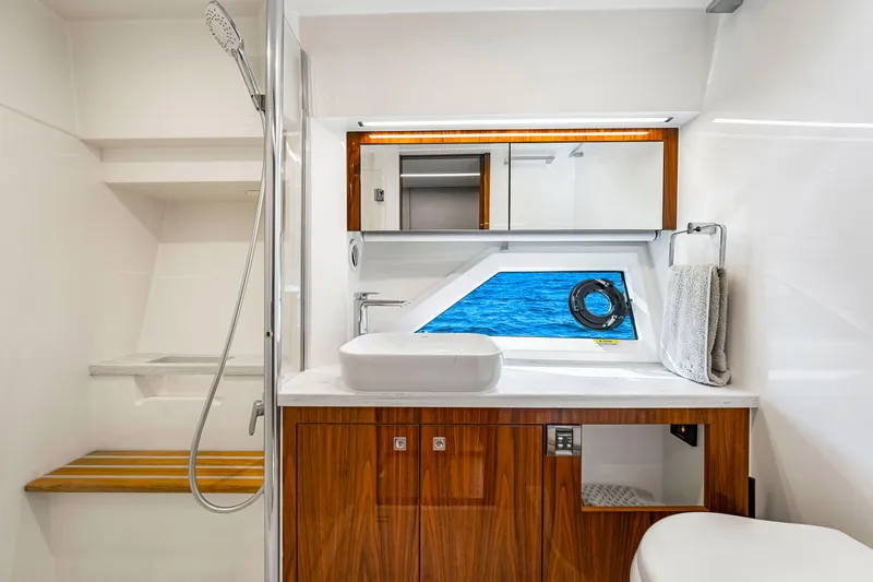 Slide: The Image of Luxurious bathroom in 2022 Riviera 505 SUV yacht with ocean view window. - 17