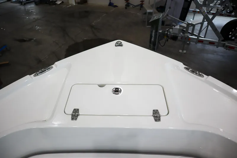 Slide: The Image of Bow of 2025 Parker 18SE Center Console boat in showroom setting. - 15