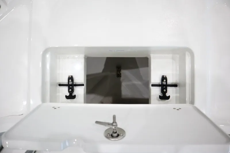 Slide: The Image of 2025 Parker 18SE Center Console storage compartment with secure latch and sleek design. - 17