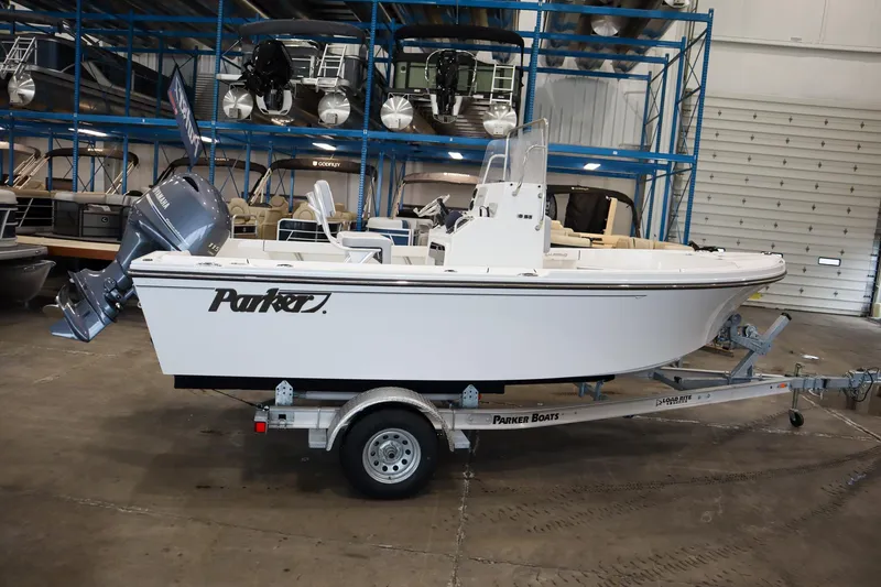 Slide: The Image of 2025 Parker 18SE Center Console boat on trailer in warehouse setting. - 2