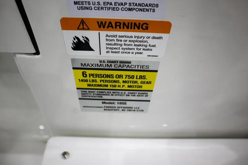 Slide: The Image of Warning label on 2025 Parker 18SE Center Console boat, showing capacity and safety information. - 20