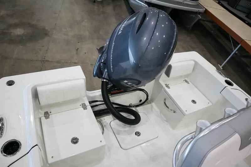 Slide: The Image of 2025 Parker 18SE Center Console boat with outboard motor, featuring spacious rear seating. - 5