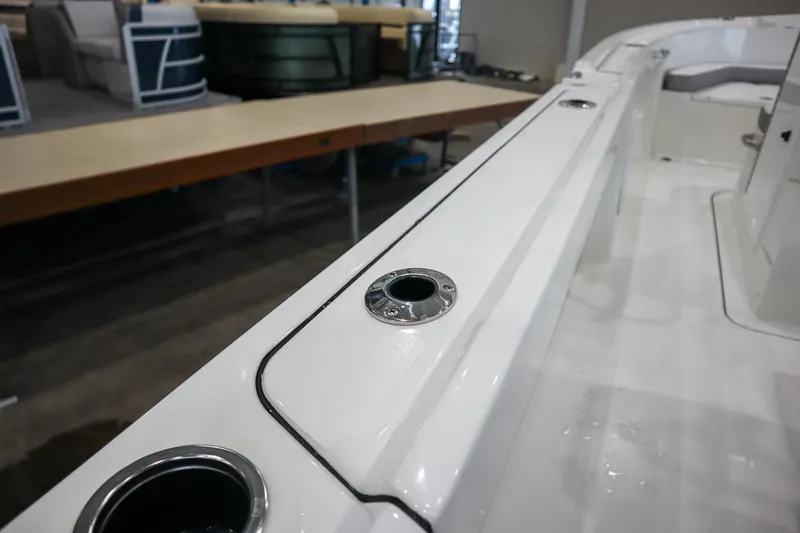 Slide: The Image of 2025 Parker 18SE Center Console boat interior with rod holders and sleek design. - 6