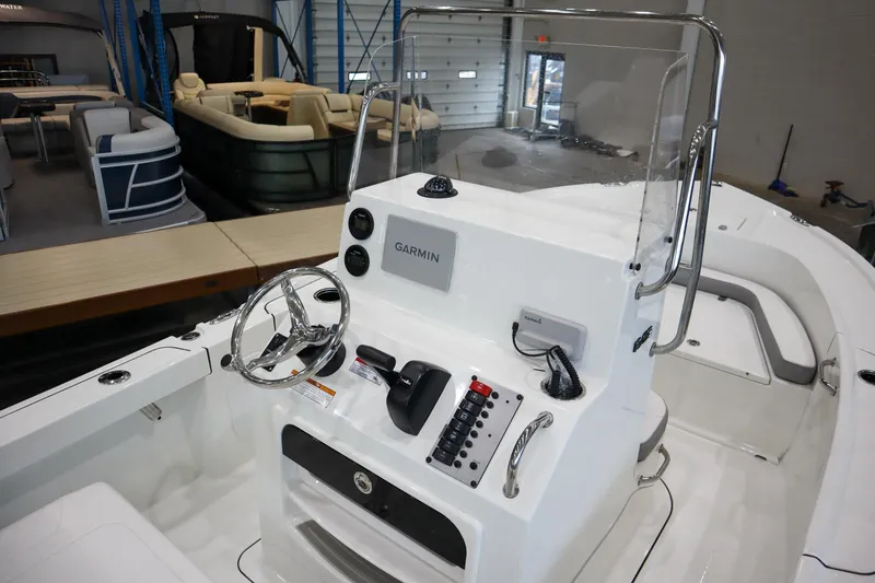 Slide: The Image of 2025 Parker 18SE Center Console boat interior with steering wheel and Garmin navigation system. - 8