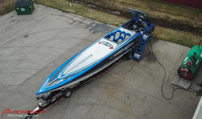 Slide: The Image of 2005 Cigarette 45 Maximus speedboat on trailer, aerial view, blue and white design. - 16