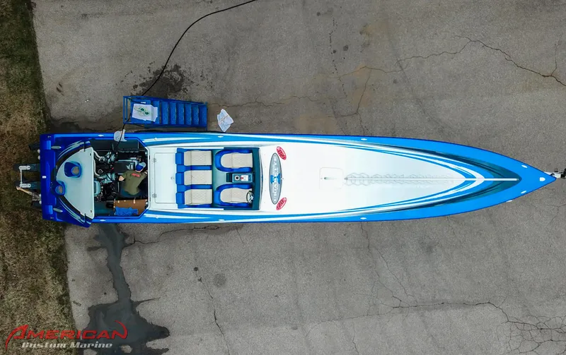 Slide: The Image of Overhead view of a 2005 Cigarette 45 Maximus speedboat with blue and white design. - 19