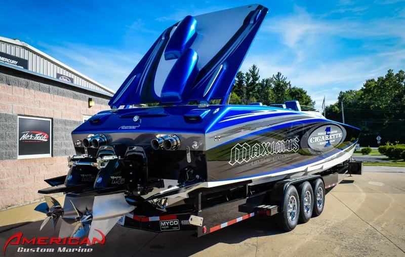 Slide: The Image of 2005 Cigarette 45 Maximus powerboat on trailer, vibrant blue and black design, at American Custom Marine. - 3