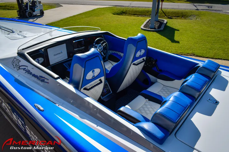 Slide: The Image of 2005 Cigarette 45 Maximus boat interior with blue and white seating, American Custom Marine branding. - 8