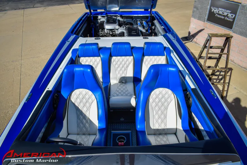 Slide: The Image of 2005 Cigarette 45 Maximus boat interior with blue and white seats, American Custom Marine branding. - 9