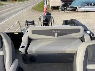 Slide: The Image of 2024 Barletta C22UC pontoon boat interior with seating and motor view. - 10