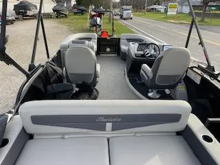 Slide: The Image of 2024 Barletta C22UC pontoon boat interior with seating and steering console. - 4